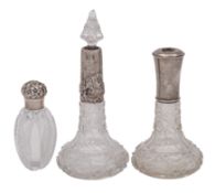 Three clear glass and silver mounted scent bottles, various makers and dates, one stopper missing.