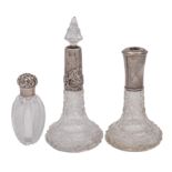 Three clear glass and silver mounted scent bottles, various makers and dates, one stopper missing.
