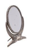 An Edward VII silver oval swing frame easel dressing table mirror,
