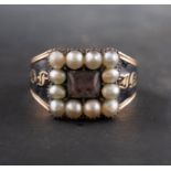 A Georgian mourning ring, glazed hairwork to centre, with seed pearl surround,
