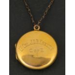 An early 20th century circular locket pendant, stamped '9CT BACK & FRONT',