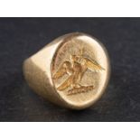 A signet ring, engraved with a heraldic device, stamped '750', length of ring head ca. 1.