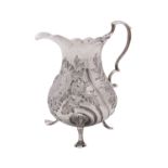 A George III silver cream jug, maker's mark rubbed, London 1765, of baluster form,