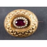 A foil backed, probably red paste and seed pearl locket brooch, with glazed compartment to verso,
