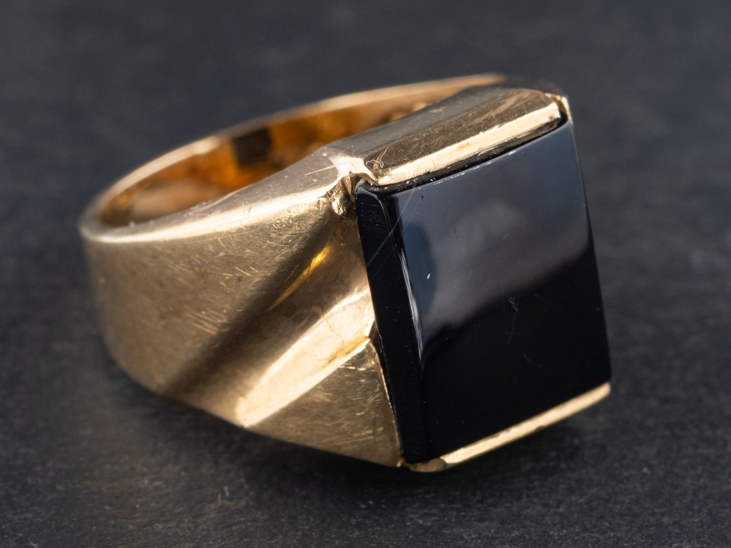 A rectangular onyx signet ring, stamped '14K, length of ring head ca. 1.