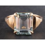 An octagonal, step-cut aquamarine ring, with stepped shoulders, estimated aquamarine weight ca. 5.