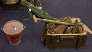 A collection of militaria comprising a WWII tent with mallet, camp bed, fire bucket,