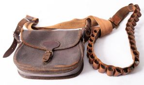 A brown leather pigskin cartridge bag, together with a brown leather 12 bore cartridge belt.