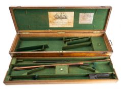 An oak and brass mounted two gun case, bearing labels to interior for Thomas Boss & Co,