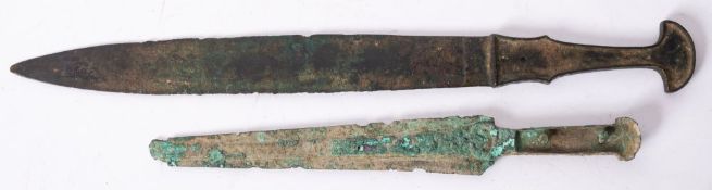 A Chinese short sword after the antique and a similar dagger, both of one piece construction,