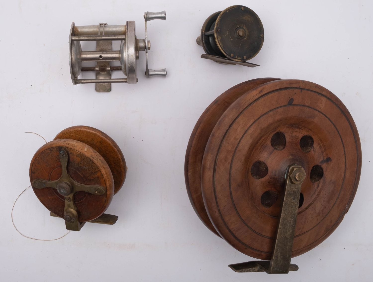 A late 19th century mahogany and brass star back reel, with double horn handles,