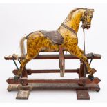 An early 20th century painted rocking horse of small size, inset glass eyes with flared nostrils,