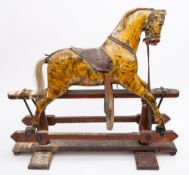 An early 20th century painted rocking horse of small size, inset glass eyes with flared nostrils,