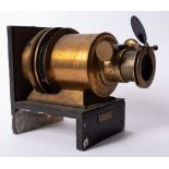 A lacquered brass 6 inch Magic Lantern lens on and ebonised base,
