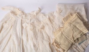 A collection of various white wear, comprising christening gowns, table linen etc in two boxes.