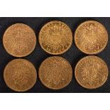 Six German gold coins comprising 20 mark pieces.