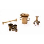 A part set of late 19th century concentric weights, together with a brass pestle and mortar,