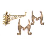 A late 19th/early 20th century brass adjustable wall bracket: the scroll decorated piecework arm