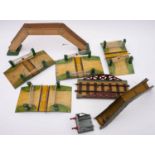 An unboxed group of four Hornby O gauge railway crossings, together with a railway bridge,