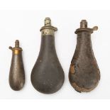 Two leather covered powder flasks with dram measure spouts and a smaller copper powder flask (3)