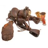 A New Mexico brown leather roping saddle, of traditional form with embossed floral decoration.