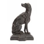 A Victorian cast iron doorstop in the form of a seated dog in a stepped base,