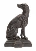 A Victorian cast iron doorstop in the form of a seated dog in a stepped base,
