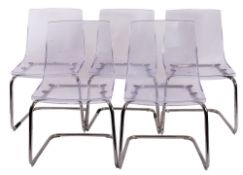 A set of five clear plastic chairs, by Ikea,