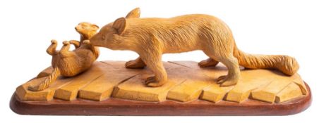 A carved beechwood and oak mounted group of an animal and its cub, by Les Jewell,