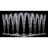 Twelve contemporary 'cross swirl' champagne flutes, with cut decoration to the bowl and stem,