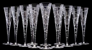 Twelve contemporary 'cross swirl' champagne flutes, with cut decoration to the bowl and stem,