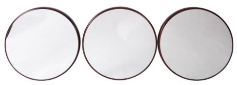 A set of three stained wood framed circular wall mirrors,