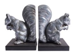 A pair of Continental spelter and marmo nero Belgio mounted bookends modelled as squirrels,