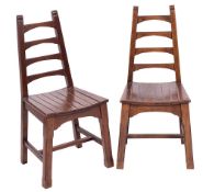 A pair of oak side chairs, in Arts & Crafts style, by A.J.