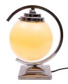 A chromed metal and opaque glass table lamp in Art Deco style,