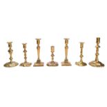 A group of seven 18th century and later brass candlesticks.