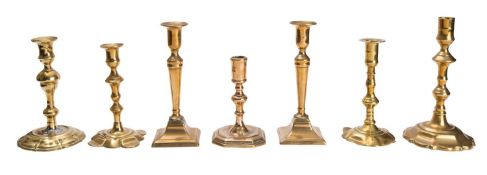 A group of seven 18th century and later brass candlesticks.