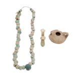 A Roman glass phial together with an antique bead necklace,