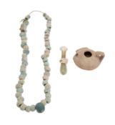 A Roman glass phial together with an antique bead necklace,