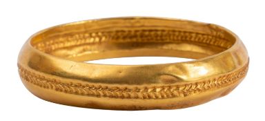 A yellow metal bangle after the Antique,