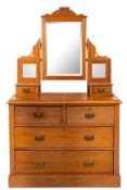 An Edwardian satin beech dressing table chest,