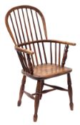 A Victorian elm and ash hoop back Windsor chair, probably Thames Valley, with iron re-forced arms,