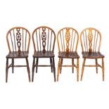 A composed set of four ash, elm and beech wheelback chairs,