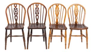A composed set of four ash, elm and beech wheelback chairs,