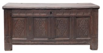A Charles II oak coffer, circa 1670; with hinged cover above a simple chip carved frieze,