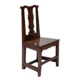 A George II oak hall chair, circa 1740.