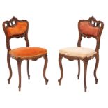 A pair of Victorian carved walnut and upholstered side chairs in Rococo Revival style,