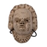 A small Staffordshire saltglaze mask of a child formally probably part of a pew group,