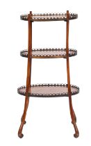 A 19th-century French walnut oval three-tier etagere;