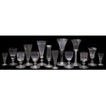 A mixed group of drinking glasses, comprising an opaque twist wine glass [chips to foot rim],